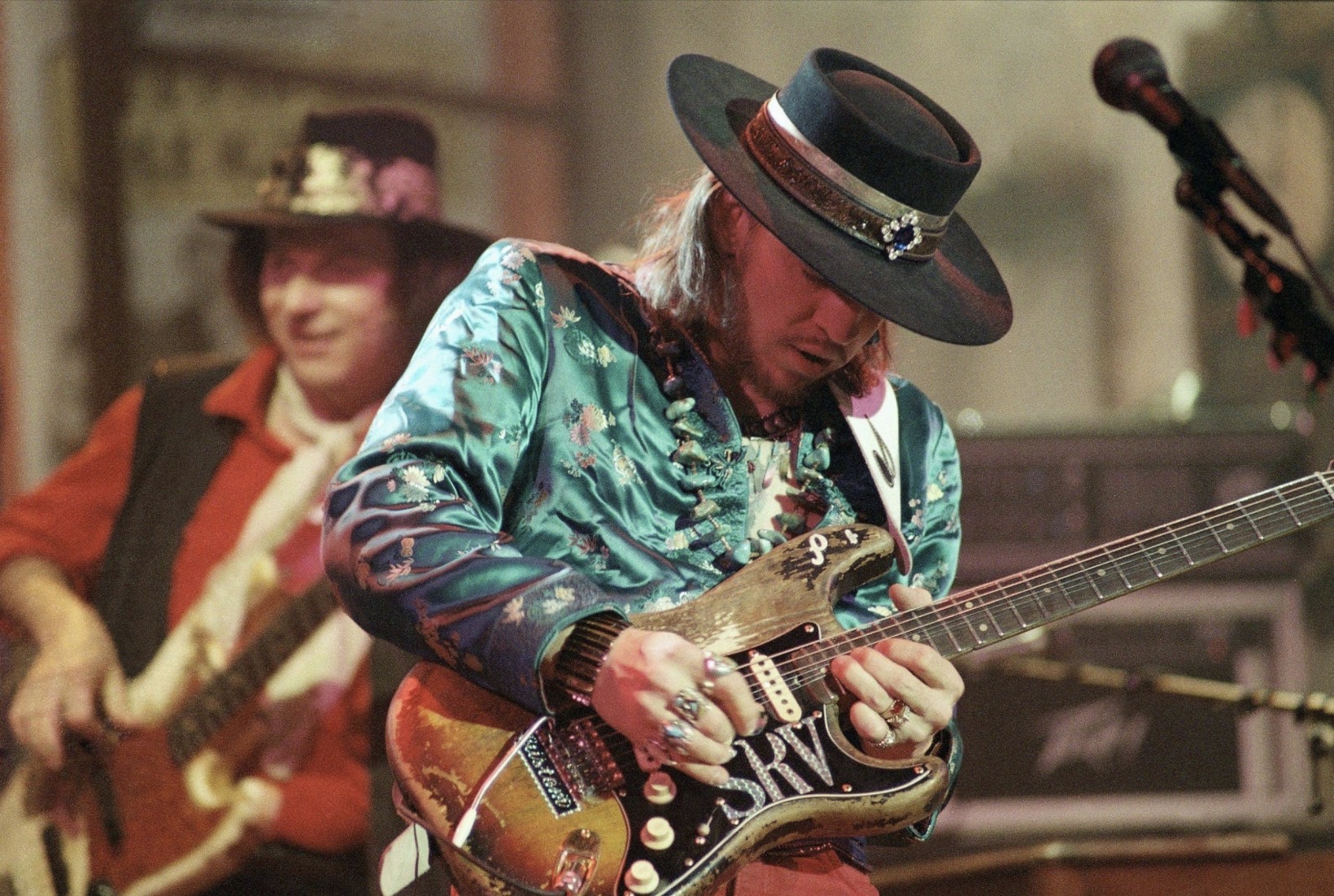 Stevie Ray Vaughan playing guitar on stage